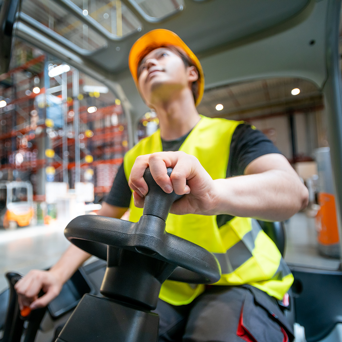Warehouse worker operates a forklift